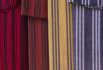 
Four multi-colored striped cotton scarves