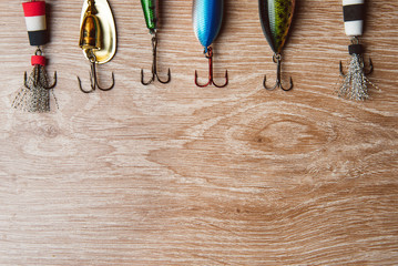 Fishing lures on a wooden background close up