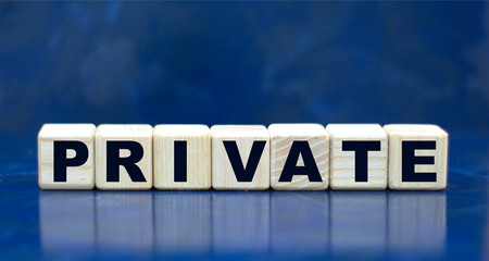 concept word PRIVATE on cubes on a blue background