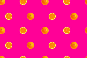 orange halves on bright pink background seamless pattern