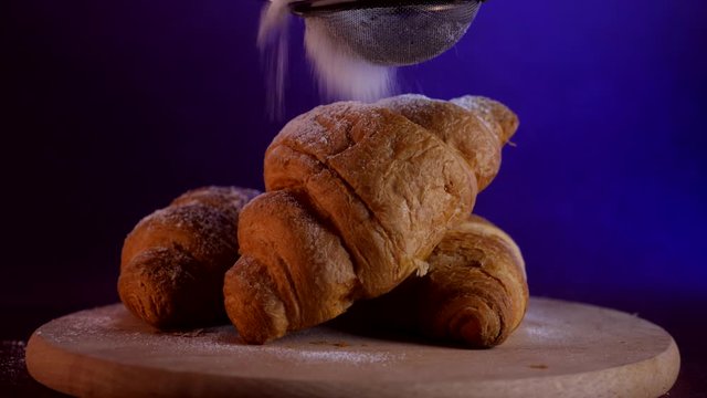 Croissants closeup with powdered sugar on the table