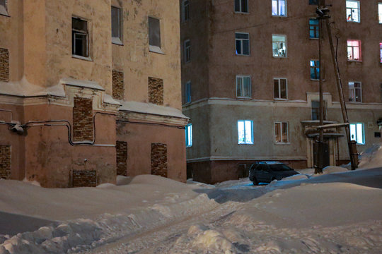 Night city in the winter. The snow-covered town in the far North
