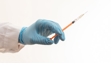 Doctor hand injecting medicine with syringe isolated against white background, closeup