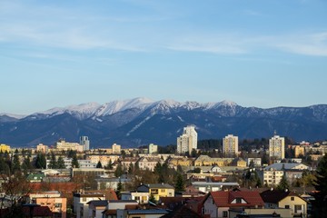Sunrise and sunset, beautiful clouds over the meadow, hills and buildings in the town. Slovakia
