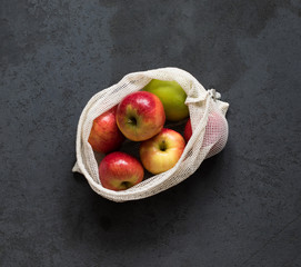 Apples in a bag on a dark background top view