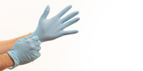 Doctor putting on medical gloves isolated on white background.