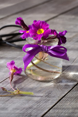 Spring flowers in bottle on wooden table