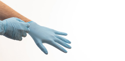 Doctor putting on medical gloves isolated on white background.