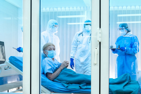 Elderly Covid-19 patient lying in quarantine room waiting to diagnosed by medical team. Poor women are suffering from lung infection in restricted area. Part of coronavirus 2019-2020 global pandemic 