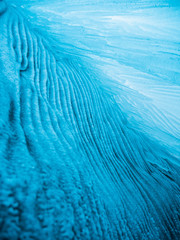 Blue ice background. Ice stalactites stalagmites. The ice of lake Baikal