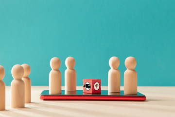 Online services. E-payments via mobile app. On-line payments. Wooden figure on cellphone, red cubes, wifi, truck sign