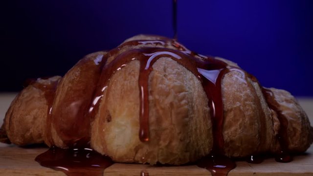 delicious croissant with cherry syrup close up