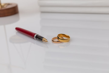 Couple with divorce contract and ring on desk. Divorce.