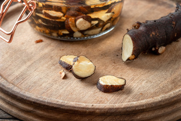 Cutting up fresh comfrey root to prepare tincture