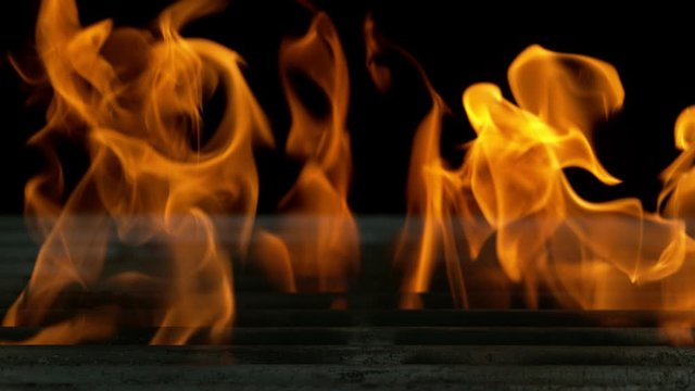 Super slow motion of empty grill grid with fire on black background. Filmed on high speed cinema camera, 1000 fps