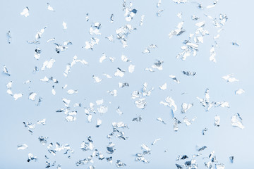 Silver sparkles on blue classic color pastel trendy background, festive backdrop for your projects.