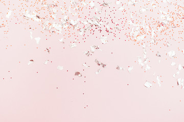 Silver sparkles on pink pastel trendy background, pink backdrop for your projects.