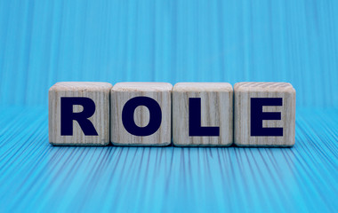 the concept of the word ROLE on cubes on a blue background in a stripe