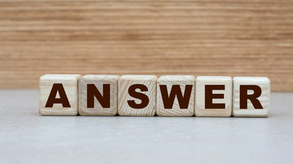 concept of the word ANSWER on cubes on a wooden background