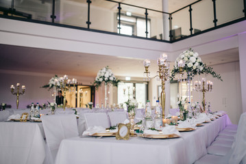 Festively decorated tables for the guests on the wedding