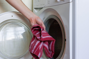 Housework: man doing laundry with washing machine at home