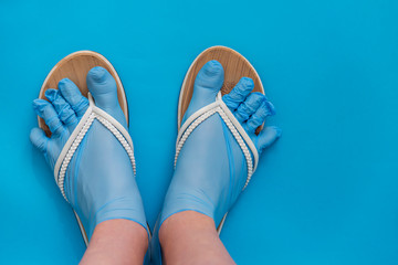 A girl’s feet in sterile disposable gloves dressed as socks and shale - this summer’s trend is...