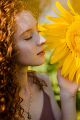 Red hair girl in sunflowers fields