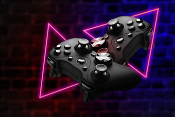 The concept of a video game, competition in e-sports. Joysticks on a dark brick background.