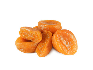 Heap of glossy whole and halved dried apricots isolated on white background           