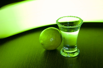 tequila with salt and lime on a green background
