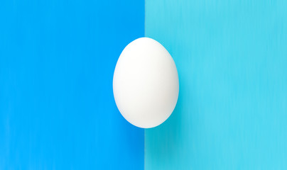 Easter egg on colorful bright blue split background