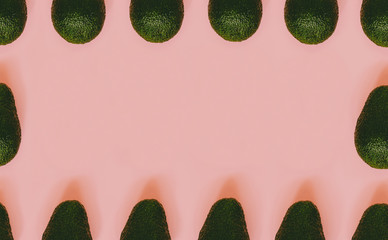 Frame from avocado on a pink background. Pop art design. Place for your text.