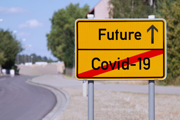Yellow sign points away from Covid-19 to future