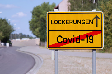 Yellow sign points away from Covid-19