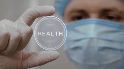 Doctor looks at innovative holographic projection with text Health. Male scientist in medical mask conducting technological research on hologram. Concept of futuristic medicine, device future science - Powered by Adobe