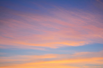 Blue sky at sunset with bright stains of orange and pink. Concept landscape, abstraction.
