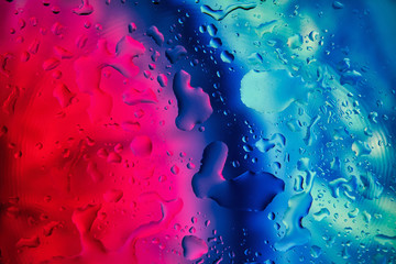 water drops on a glass with red and blue background