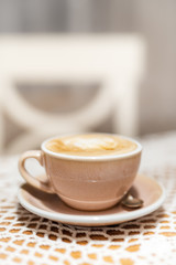 Cup of cappuccino on table with soft blurred background
