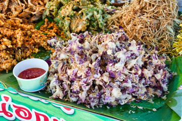 Thai deep fried colorful Ixora flowers food on a street market near to Bangkok on Koh Kret island in