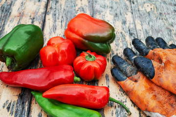fresh red green peppers on a wooden table