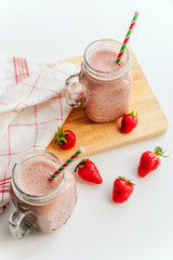 Fresh strawberry milkshake in glass, smoothie with berries. and fresh strawberries. Healthy food and drink concept. Healthy food for breakfast and snack. copy space