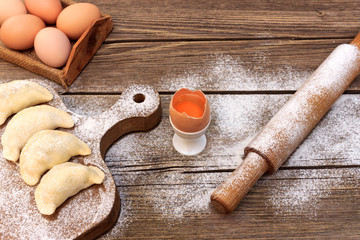 Cooking dough pies on a dough board © Roman