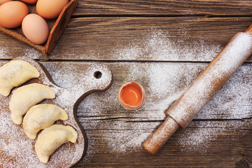 Background with flour and eggs on a wooden table