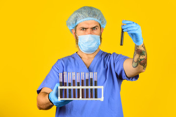 Critical number or density of susceptible hosts. Man in medical lab inspecting samples biological...