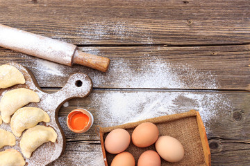 Making pasta and egg tarts on a wooden board