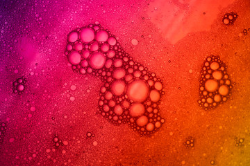 Closeup beautiful liquid bubble on surface colorful background