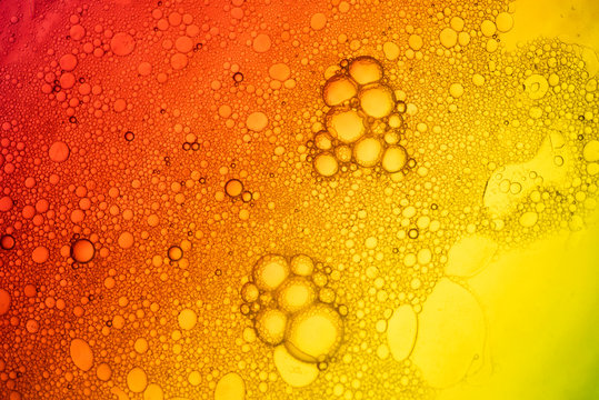 Closeup beautiful liquid bubble on surface colorful background
