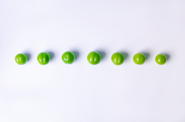 green plums on white ground