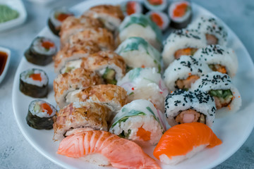 Sushi set on a large white oval plate. Soft focus.