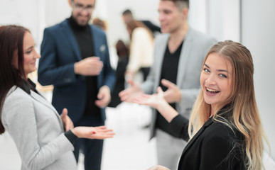 young business woman standing among her colleagues